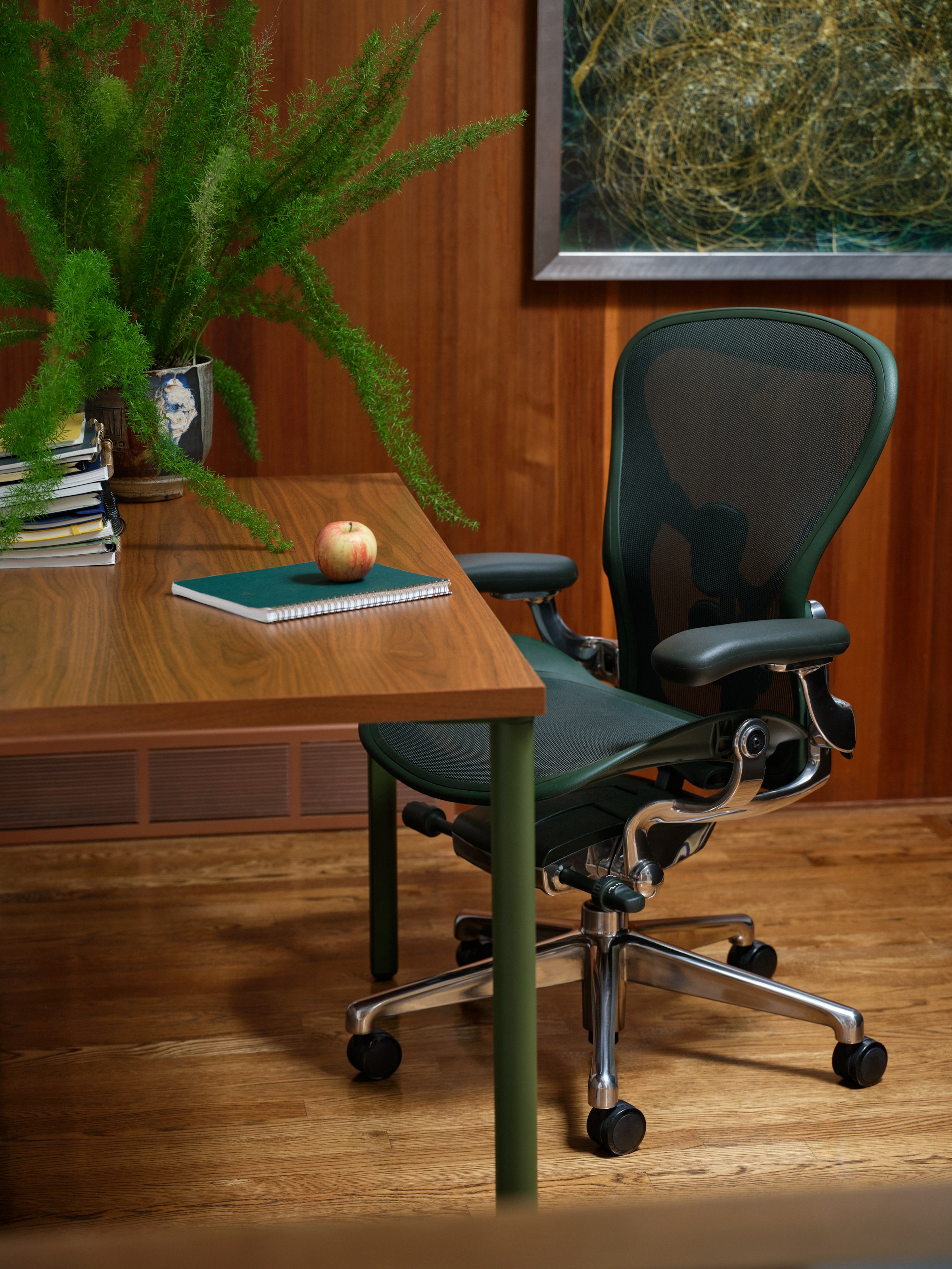 Herman Miller Aeron in Jasper beside a walnut table